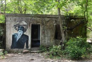 This picture taken on June 18, 2018 shows a mural at the now-derelict ashram visited by the Beatles 50 years ago, in Rishikesh in northern India. - Fifty years after the Beatles came to India, the bungalows where the Fab Four lived, the post office where John Lennon sent Yoko Ono postcards and the giggling guru's house are all ruins. (Photo by Sajjad HUSSAIN / AFP)        (Photo credit should read SAJJAD HUSSAIN/AFP via Getty Images)